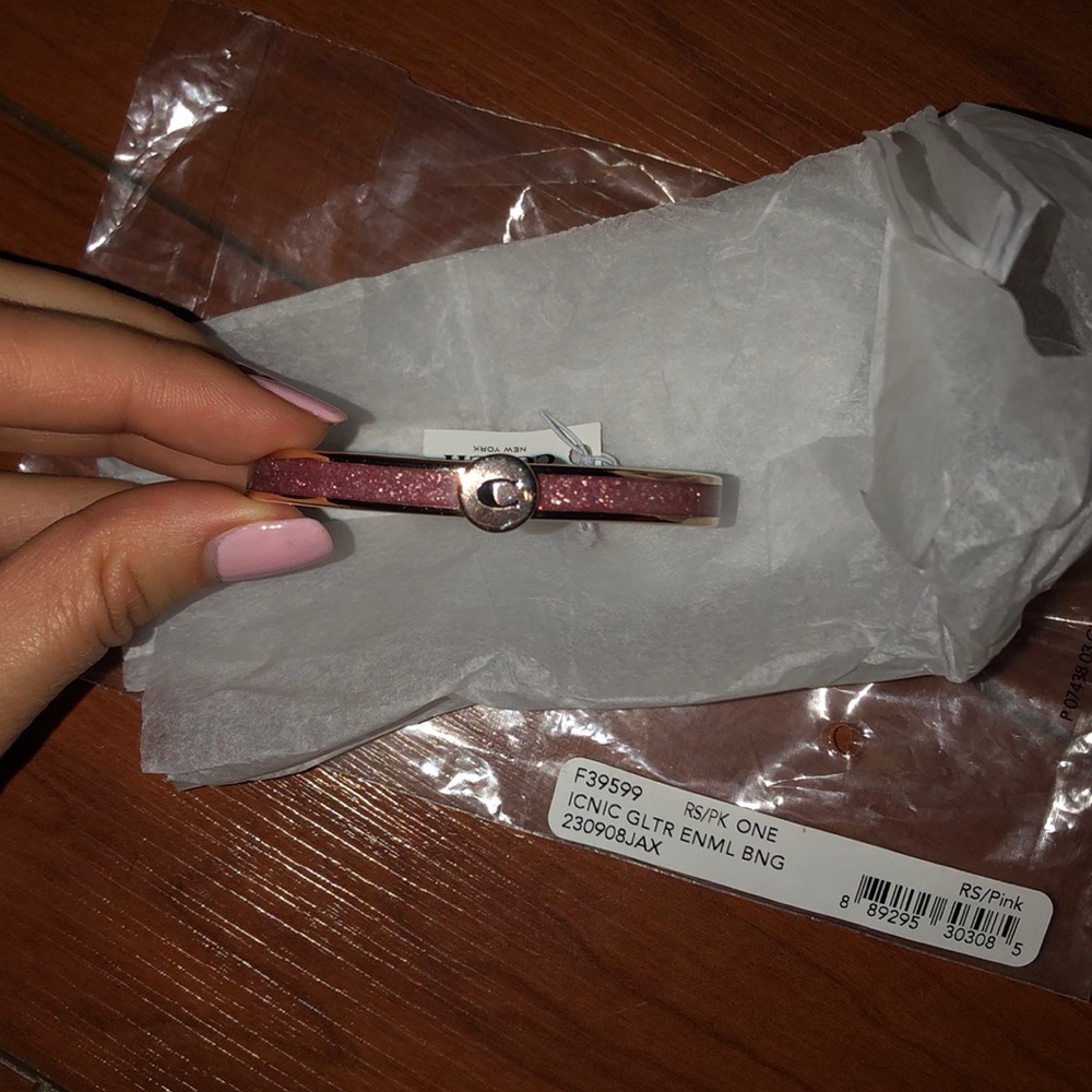 Coach gold with pink sparkly bracelet